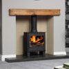 The Malvern multi fuel stove shown in a contemporary fireplace with wood mantlepiece.
