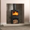 A charlton & jenrick Fireline FQ5 multi-fuel stove in a contemporary stone fireplace.