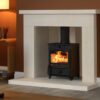Fireline FX5 multi fuel stove in a traditional white stone fireplace with brown painted walls.