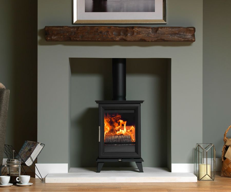 A Charlton & Jenrick Woodtec 5 Style wood burning stove set in a contemporary fireplace with oak mantle.