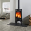 A Dovre Bold 300 freestanding cylindrical stove shown in a contemporary living space.