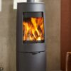 A Dovre Bold 400 cylindrical wood-burning stove shown in a contemporary living room.