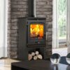 A Portway P1 Contemporary multi-fuel stove shown without a fireplace against a brick wall with logs stored underneath.