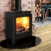 the Portway Arundel wood stove shown on a wooden floor with brick wall.
