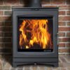 The Portway Luxima Wood is a wood-only stove which is shown in a brick fireplace with logs burning within.