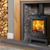 A Portway Rochester 5 multi-fuel stove shown in a contemporary living room with grey painted walls and brick fireplace.