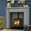 The Saltfire ST1 Vision stove in a contemporary grey fireplace with brick lining.