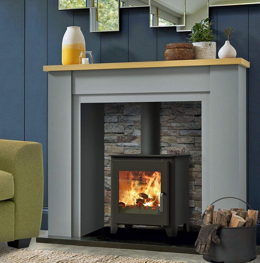 The Saltfire ST1 Vision stove in a contemporary grey fireplace with brick lining.