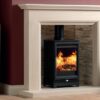 Woodtec 5 stove shown in a traditional stone fireplace with burgundy painted walls