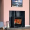 A Charlton & Jenrick Woodtec 5WD wood-burning stove set in a pink painted chimney breast