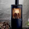 A cylindrical wood-burning stove shown in a contemporary living space.