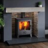 A Capital Scene Eco stove burning in a fireplace painted dark grey in a living room.