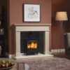 A cosy living room with terracotta painted walls and a Fireline FT5W stove burning in the stone fireplace.