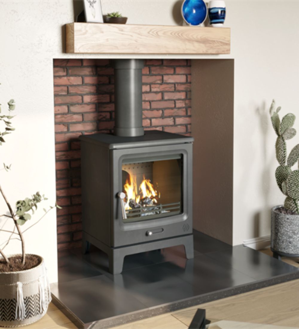The F2 Vue Portrait woodburning stove shown in a fireplace with burning logs and brick hearth.