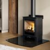 The freestanding Mendip Loxton 5 with a dark slate hearth on a wooden floor in a living room