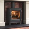 A Dik Geurts Soren 5 woodburning stove shown in a traditional fireplace with slate hearth.