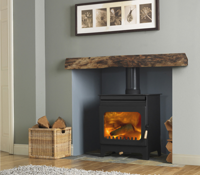 Burley Brampton Woodburning Stove shown alight in a living room with grey painted walls