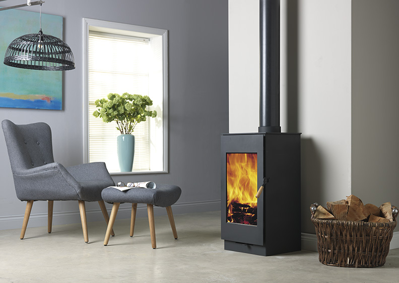 Burley Carlby Woodburning Stove shown alight in a living room with grey painted walls