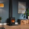 Burley Hardwick Woodburning Stove shown alight in a living room with grey painted walls