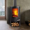 A cylindrical freestanding black Termatech wood-burning stove shown in a contemporary living room.