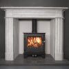 A multifuel stove shown in a chimney recess with white mantlepiece surround.