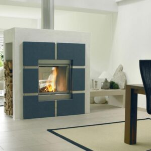 A woodburning stove which is set into a freestanding wall between two rooms so that the flames can be seen from both sides.