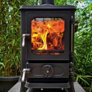 Hobbit stove pictured alight with greenery in the background